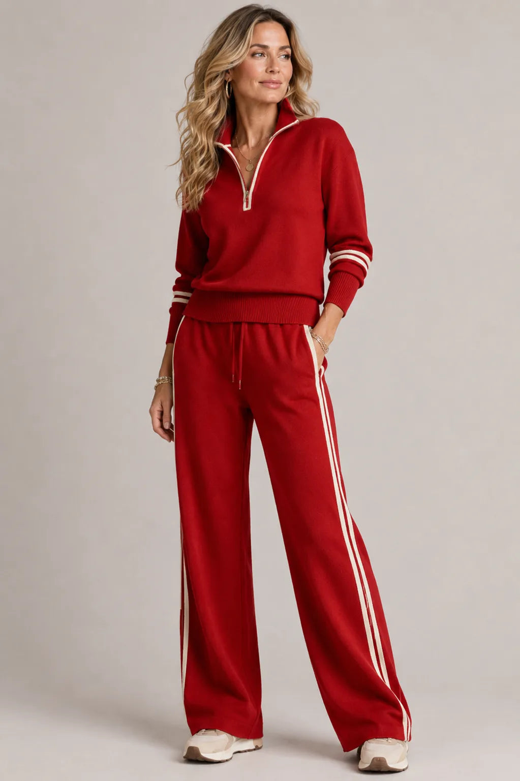 Red quarter-zip jumper and matching wide-leg trousers with cream stripe piping down the leg and cuffs
