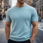 Close-up front view of a pale blue knitted tee showing the ribbed crew neckline and soft fuzzy texture