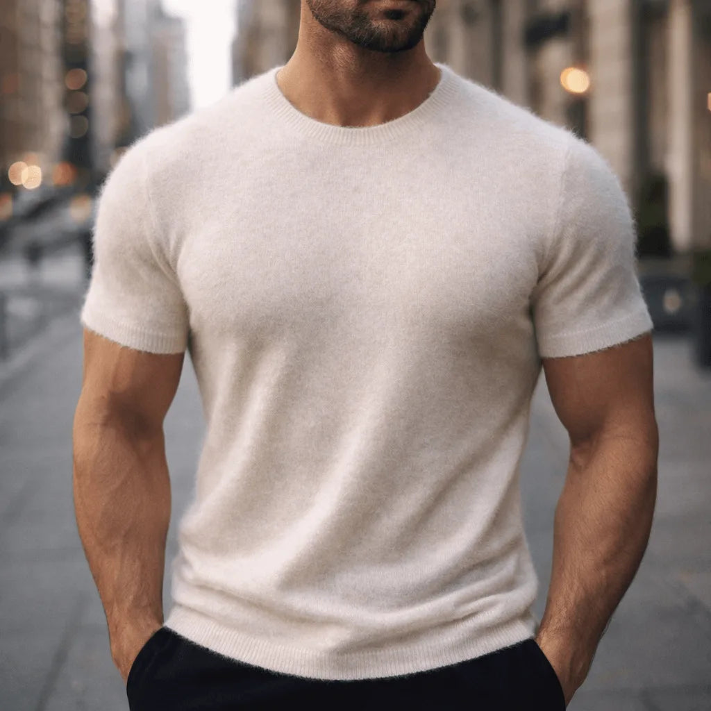Man wearing an ivory off-white short-sleeve knitted tee with a relaxed fit on a city street