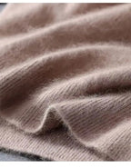 Close-up of taupe knit fabric folded to highlight its fluffy pile and ribbed trim detail