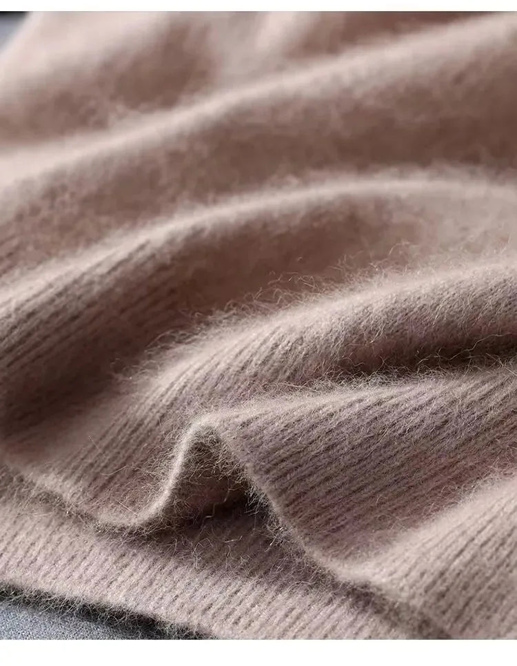Close-up of taupe knit fabric folded to highlight its fluffy pile and ribbed trim detail