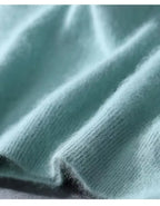 Man wearing a mint green short-sleeve knitted tee, close-up showing fabric texture and relaxed shoulder fit