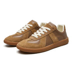Angled pair view of tan leather and suede trainers with cream laces and a gum rubber sole