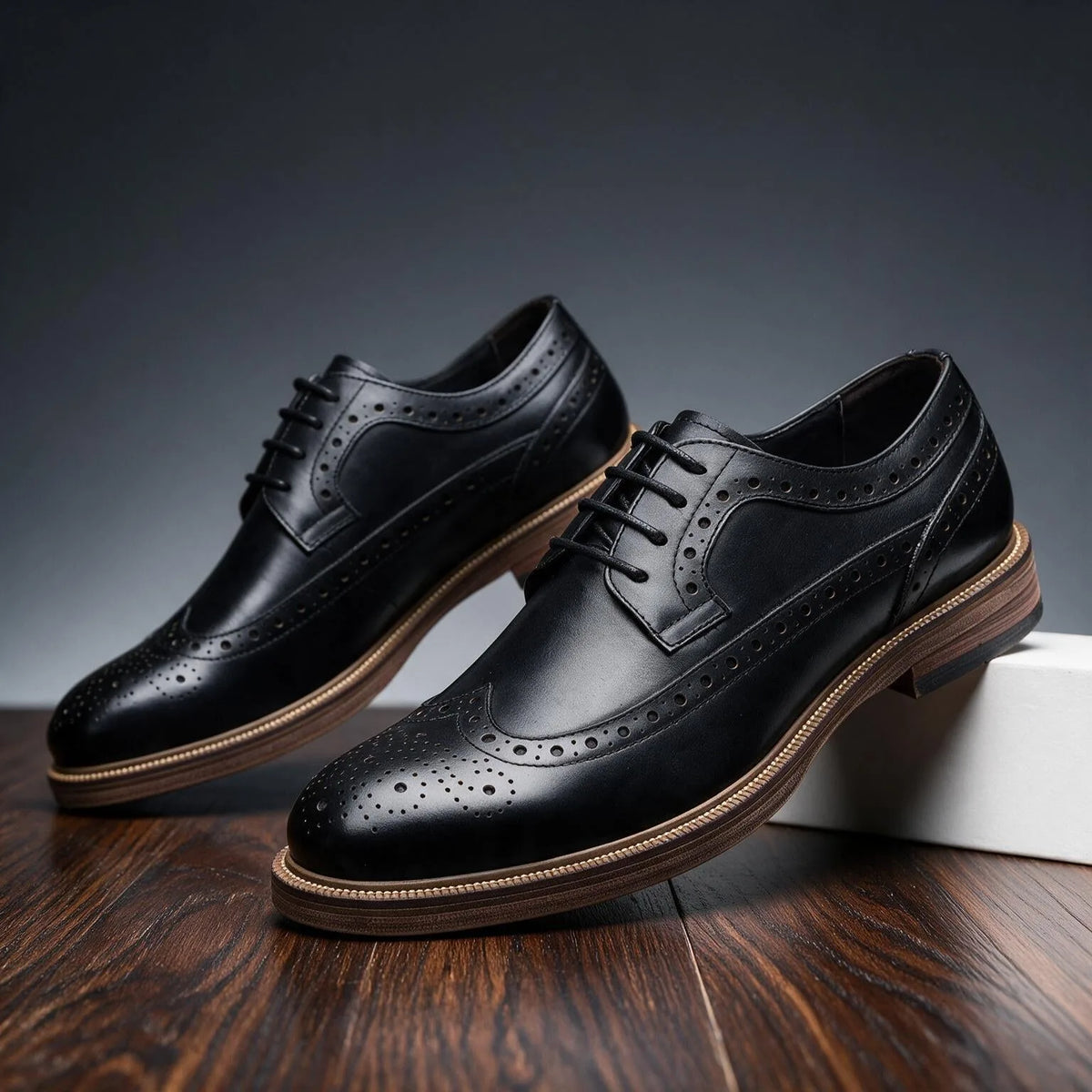 Low-angle shot of the black brogue derby shoe capturing the glossy leather finish and tonal stitching