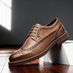 Tan brown leather wingtip brogue derby shoe in side profile showing full brogue perforations and stitched welt