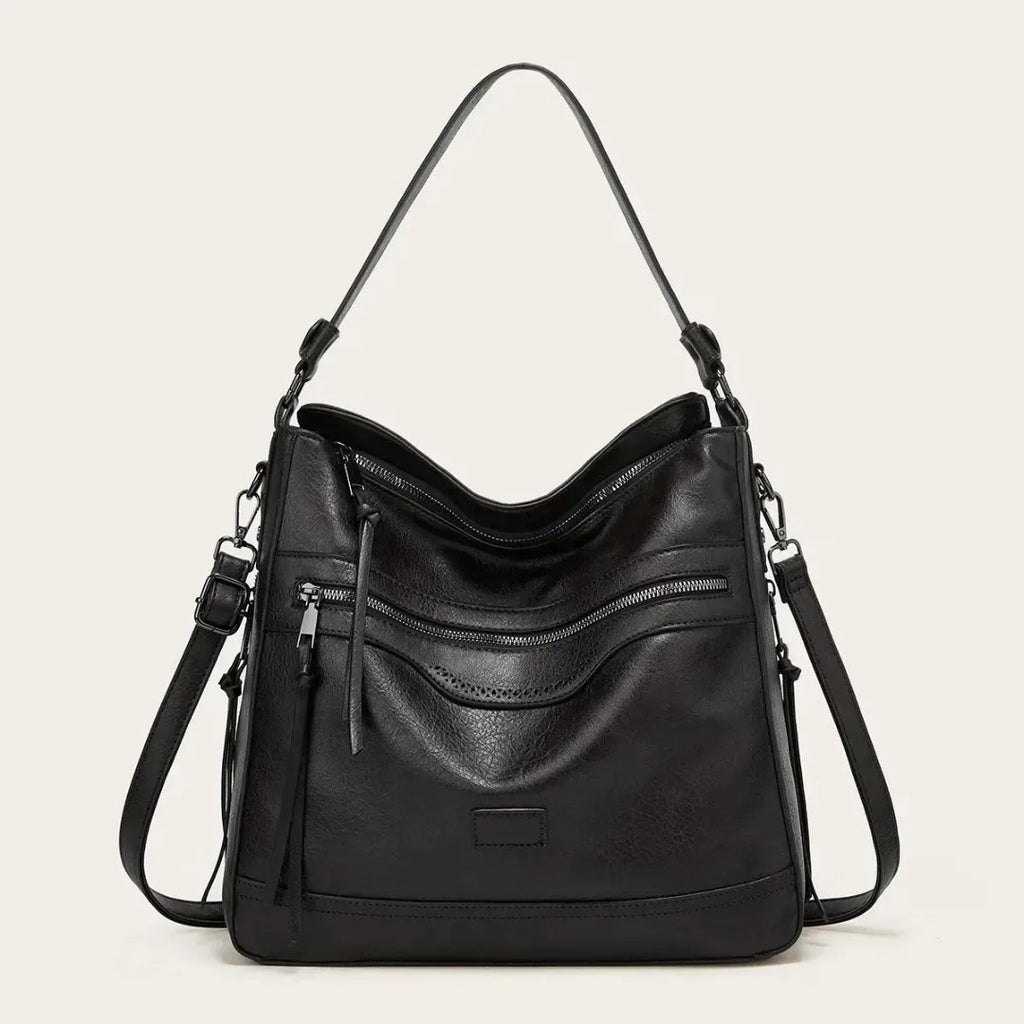 Black faux leather hobo shoulder bag shown from the front with double zip pocket detail and tassel pull