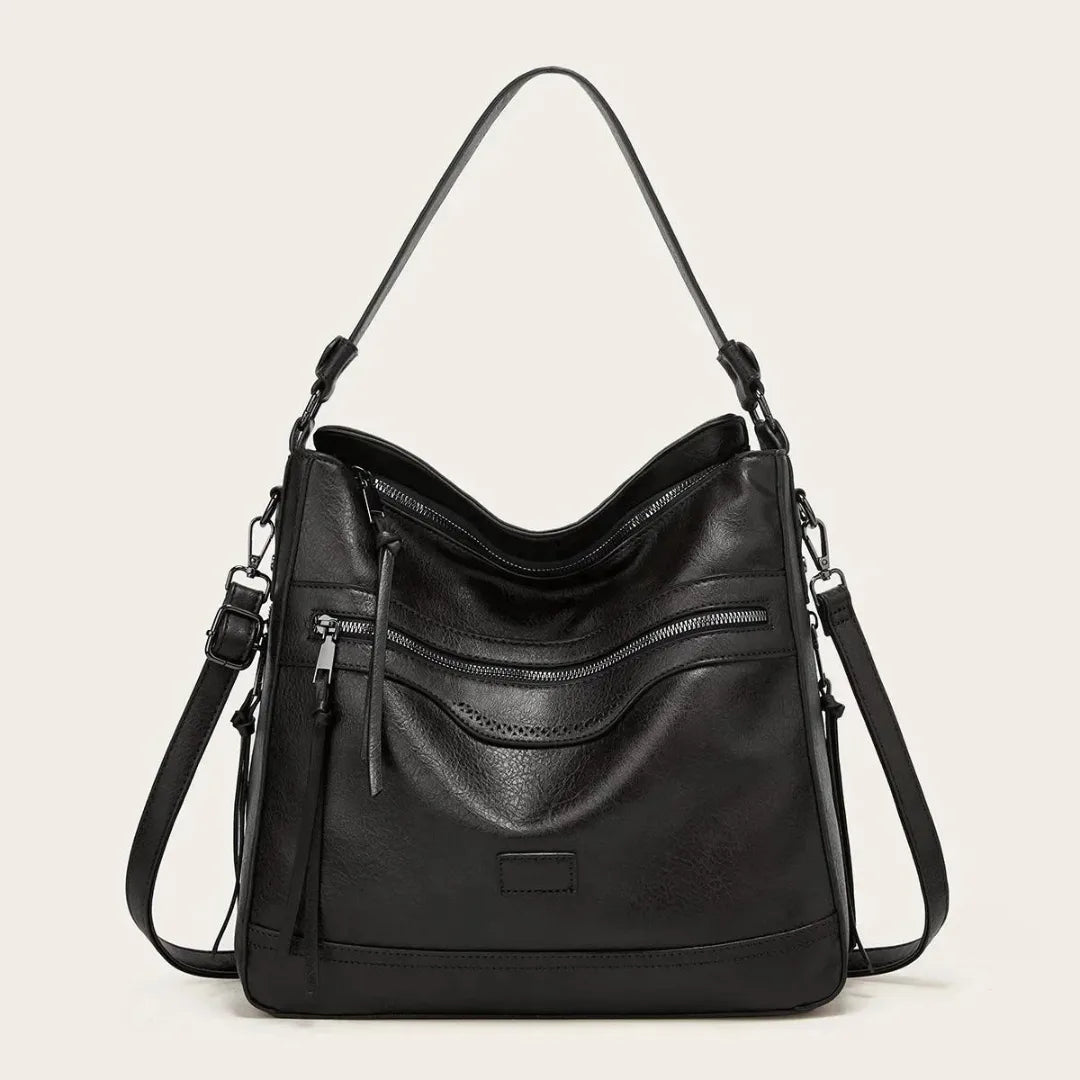 Black faux leather hobo shoulder bag shown from the front with double zip pocket detail and tassel pull