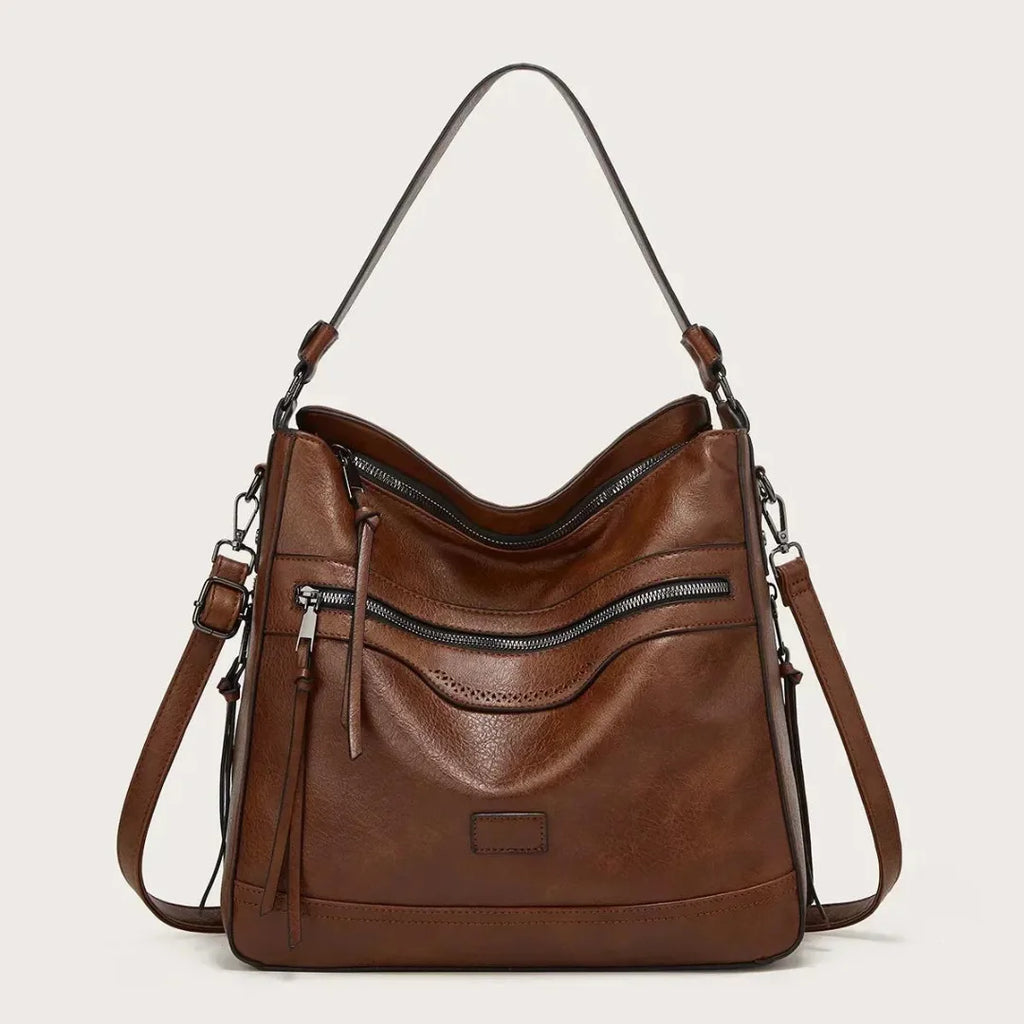 Brown hobo bag with open top zip revealing the roomy interior and adjustable crossbody strap