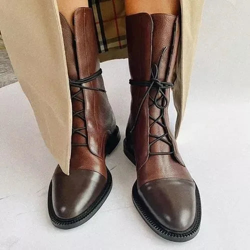 Front view of brown leather lace-up boots with contrast black laces and cap toe detail