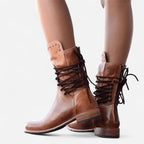 Front angle of tan brown leather lace-up boots showing the full lacing pattern and rounded toe
