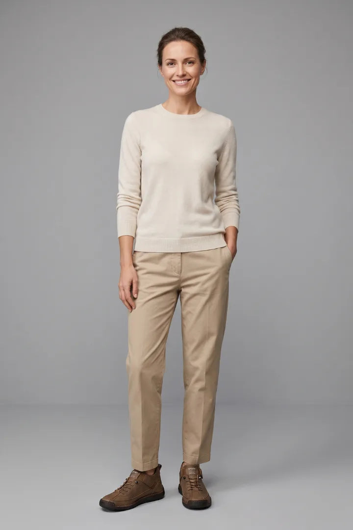 Woman in a beige jumper and beige trousers wearing brown leather lace-up comfort trainers