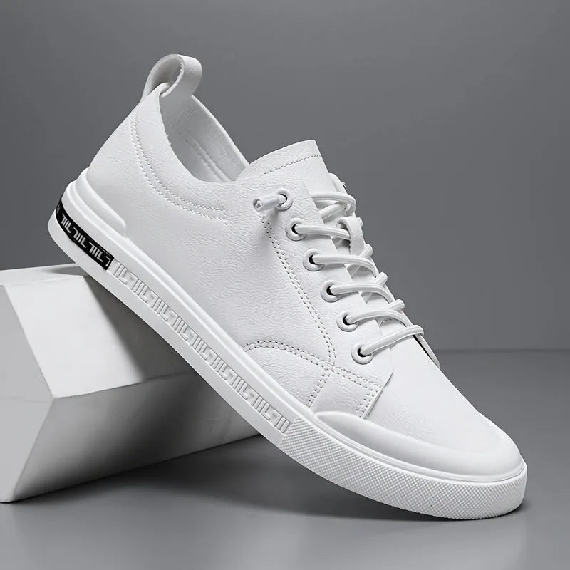 Side view of a white leather trainer with lace-up front, textured sole and stitched toe detailing