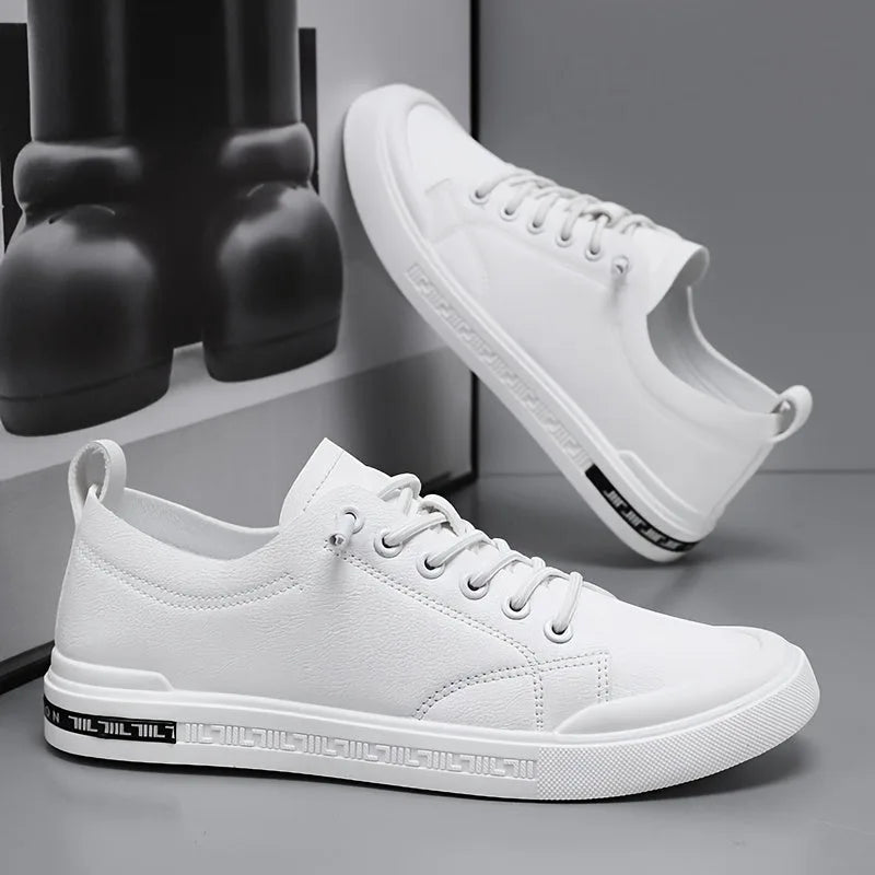 Pair of white leather trainers shown together, one resting on its side, with ridged white outsole