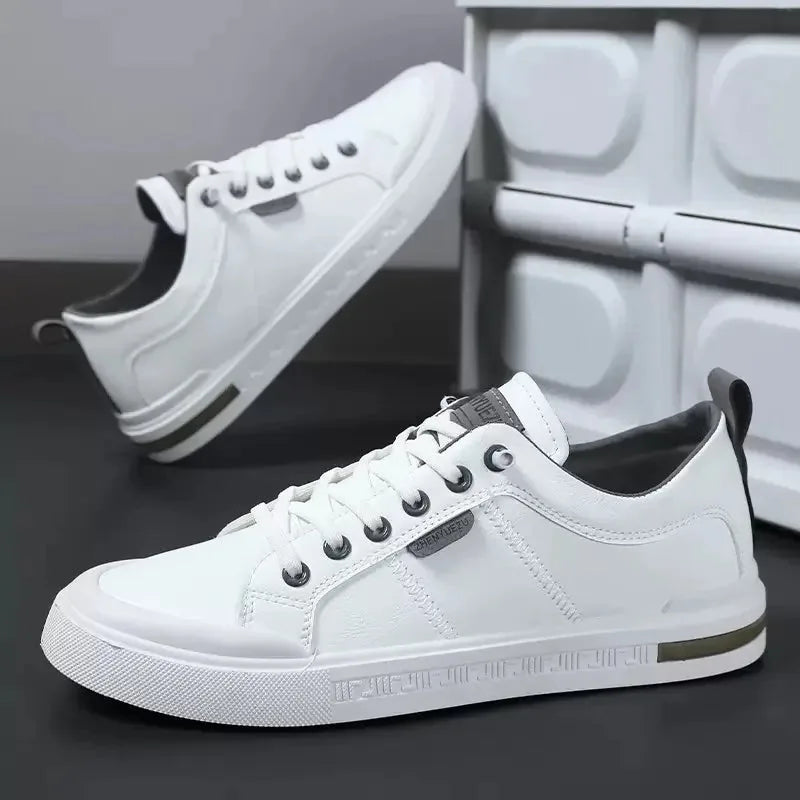 Side view of white trainer with grey pull tab, dark laces and textured rubber outsole