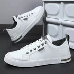 Side view of white trainer with grey pull tab, dark laces and textured rubber outsole