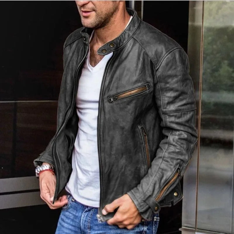Black leather-look moto jacket with stand collar, snap-button strap and zipped chest pocket, worn open over a white tee