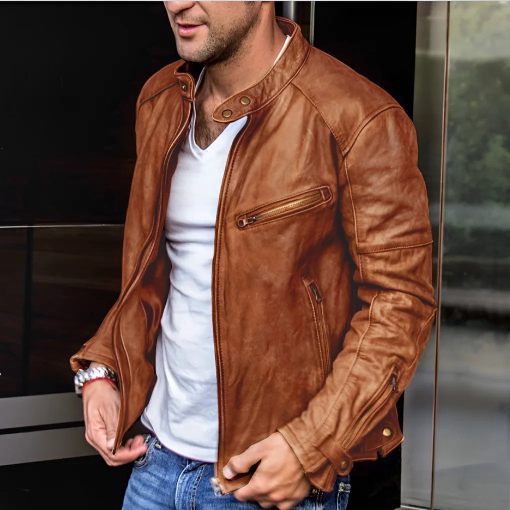 Close-up of a tan leather-look jacket showing the zipped chest pocket, stitched seams and snap-button cuff detail