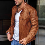 Close-up of a tan leather-look jacket showing the zipped chest pocket, stitched seams and snap-button cuff detail