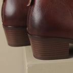 Angled view of black ankle boots highlighting the pointed toe and low heel stack