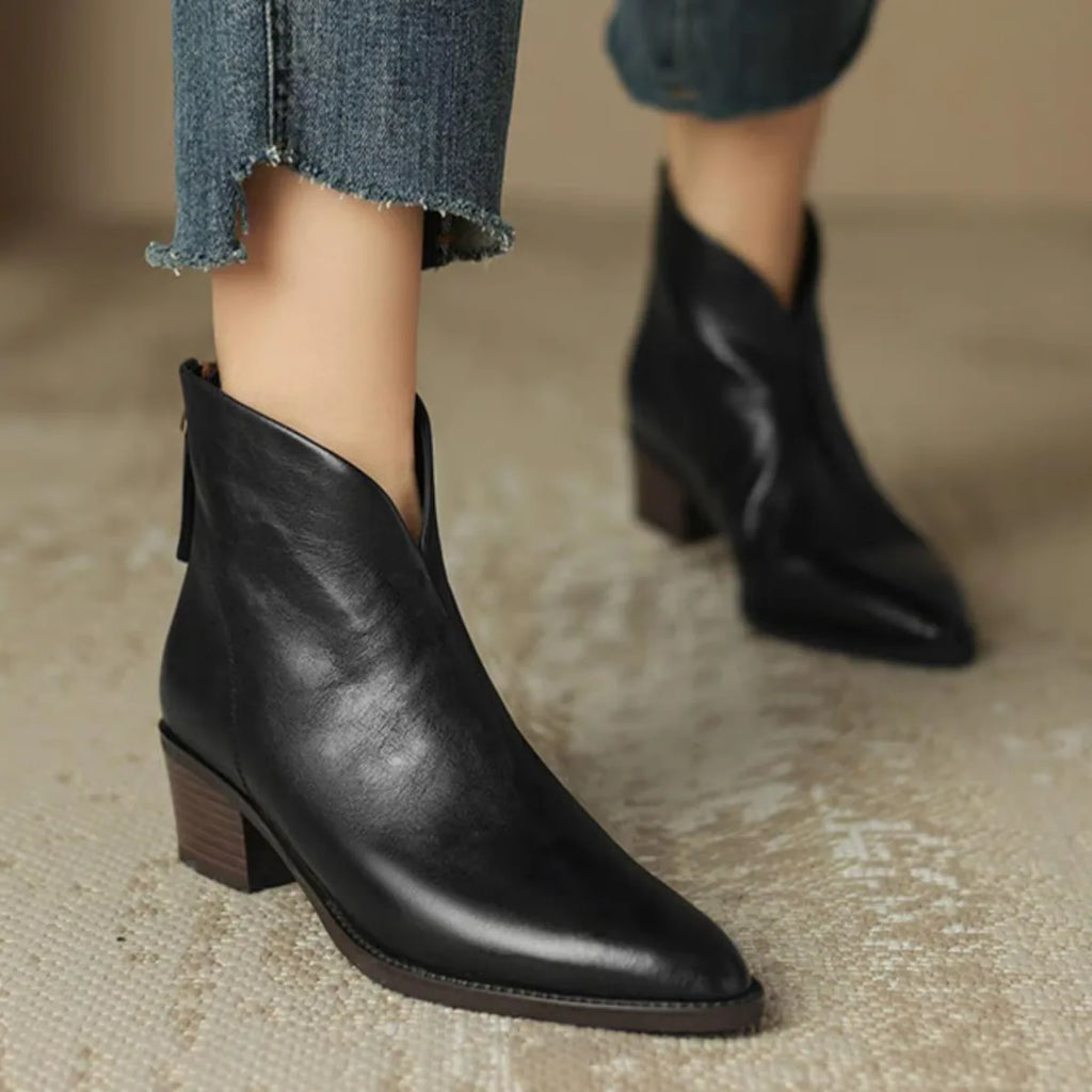 Three ankle boots lined up showing black and two brown leather finishes with pointed toes