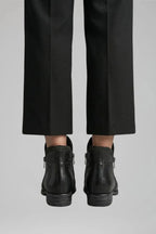Back view showing the zip closures and stitched heel seam of the black leather ankle boots