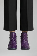 Front view of the same ankle boot style in a rich purple leather with ruched shaft
