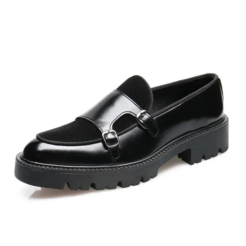 Angled shot of glossy black leather loafer with suede insert, twin buckles and chunky ridged sole on white background