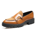 Three-quarter view of tan brown leather loafer with matching suede panel, silver double buckles and cleated platform sole