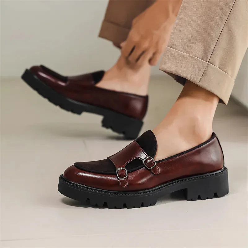 Model wearing burgundy leather double monk loafers with cropped tan trousers, showing the low chunky heel