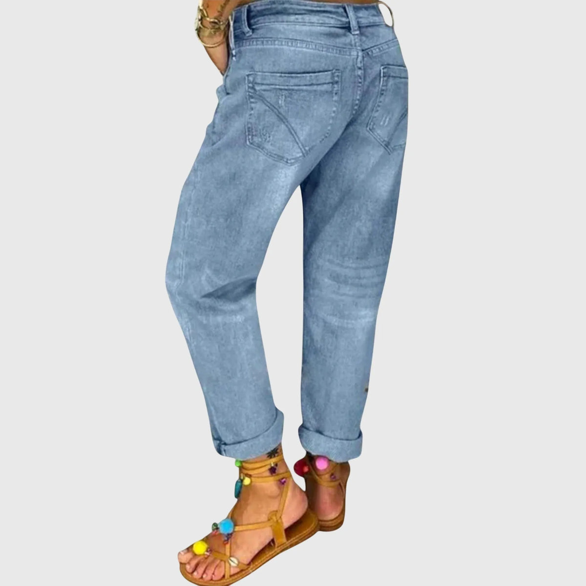 Rear view of light wash denim trousers highlighting the loose, straight-leg silhouette and back pockets