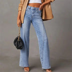Front view of light blue wide-leg jeans with high waist, worn with a white crop top and tan jacket