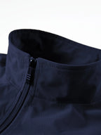 Close-up of navy gilet collar showing stand-up neck, zip fastening and smooth fabric finish