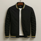 Detail view of the jacket's zip fastening and ribbed cuff with contrast stripe trim