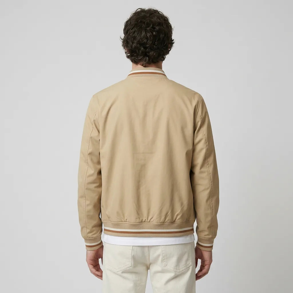 Back view of a man wearing the beige bomber jacket, showing the ribbed striped hem and plain back panel