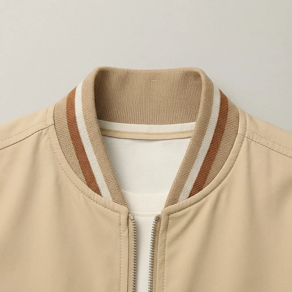 Close-up of the ribbed collar with rust, white and beige stripes and the front zip detail