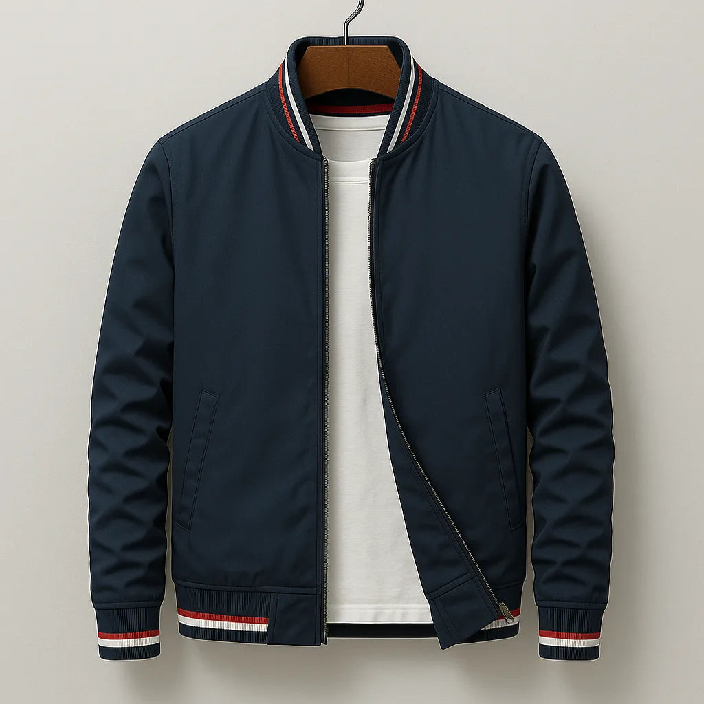 Navy bomber jacket on a hanger with red, white and navy striped ribbing at the collar and cuffs