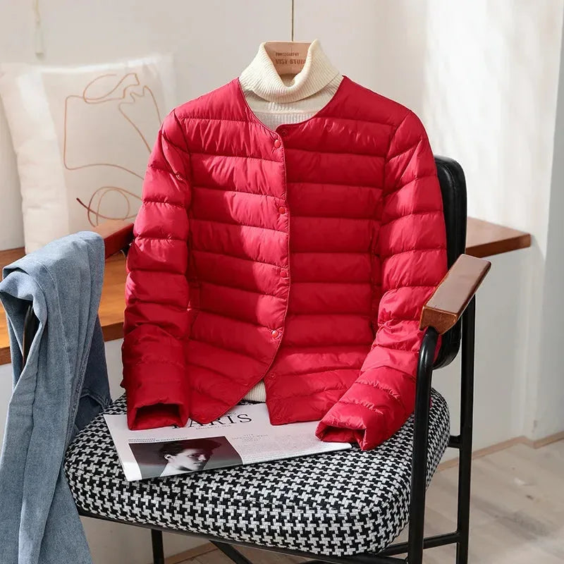 Detail of the black jacket's snap buttons and lightweight puffer quilting pattern