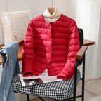 Detail of the black jacket's snap buttons and lightweight puffer quilting pattern