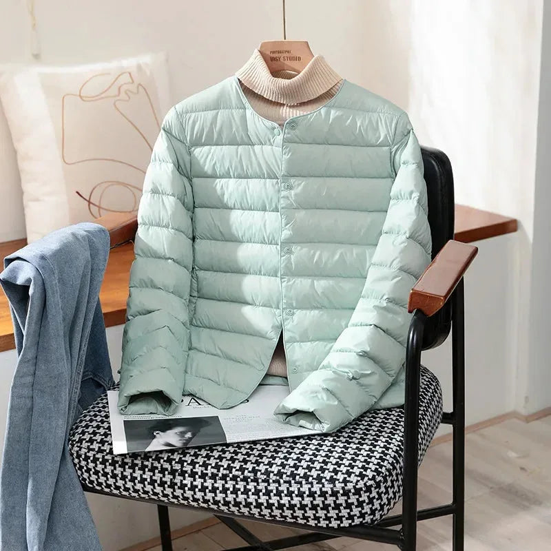 Front view of the terracotta jacket showing round neckline and snap-front button closure
