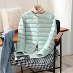 Front view of the terracotta jacket showing round neckline and snap-front button closure