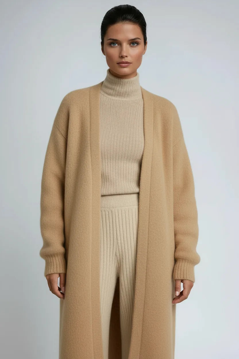 Close-up of a camel knit long cardigan worn open over a matching beige ribbed knit set