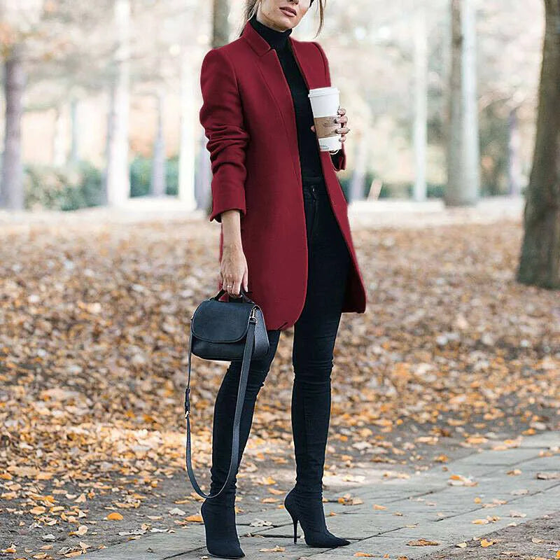 Wine red tailored longline coat with stand collar styled with black skinny jeans and heeled boots