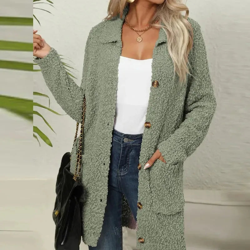 Olive green teddy jacket styled open over a white top and jeans, showing relaxed longline fit and long sleeves.