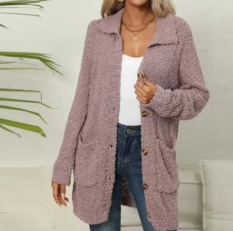 Close-up front view of a dusty purple teddy jacket showing textured fabric, buttons and patch pocket detail.