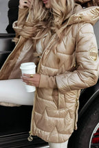Close-up of the gold puffer coat's hood, drawstring toggle and quilted star-pattern body