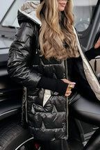 Close-up of the gold puffer coat's hood and sleeve badge, worn with a ribbed cuff jumper