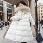 Close-up of the tie belt and buckle detail on the quilted maxi coat