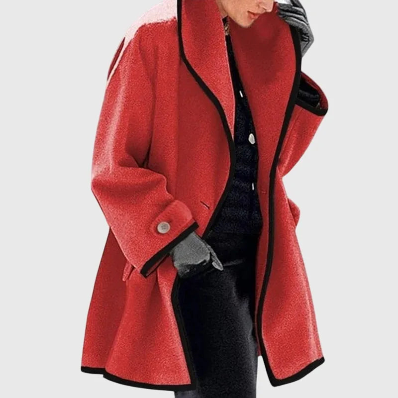 Red tailored longline coat with contrast black piping along collar, front edge and cuffs