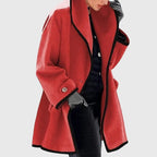 Red tailored longline coat with contrast black piping along collar, front edge and cuffs