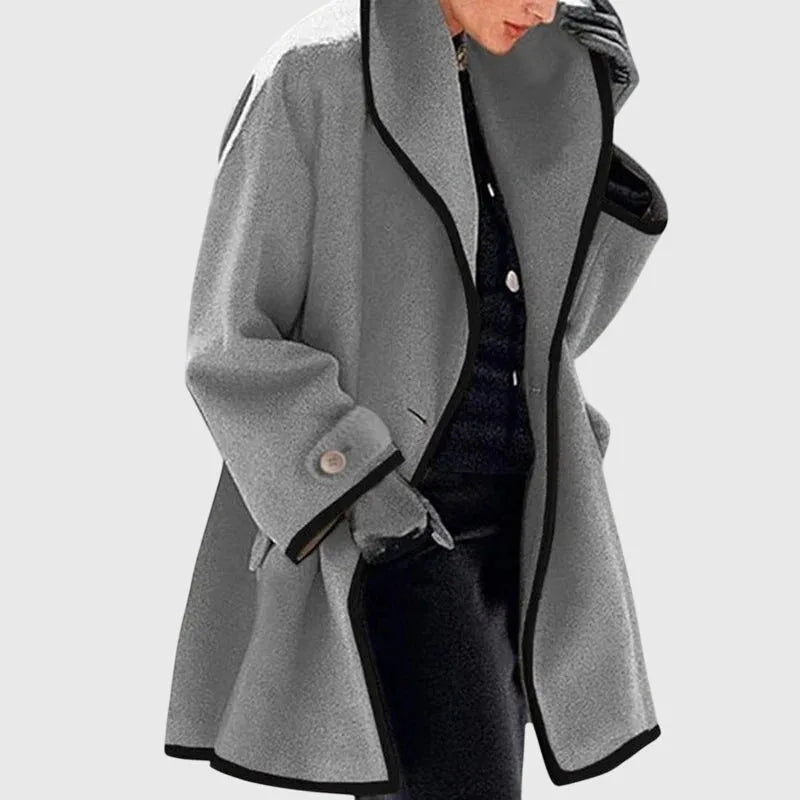 Grey longline coat with black contrast binding, relaxed drape and structured shoulder